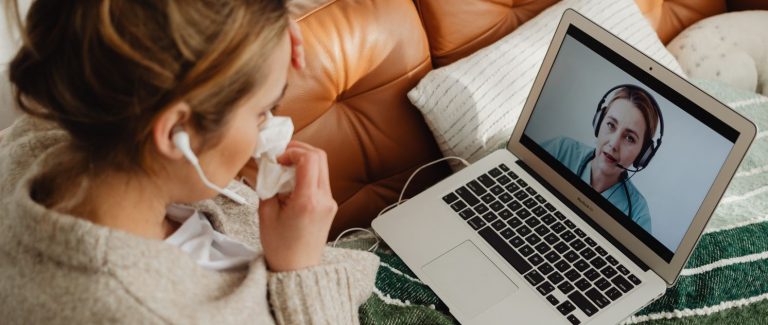 Een vrouw praat via de laptop met haar zorgverlener